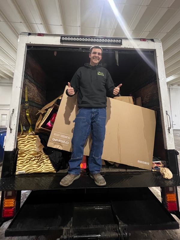 Classic Cleanouts crew member giving a thumbs up from a box truck loaded during an estate cleanout