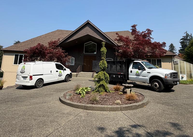 Classic Cleanouts junk removal truck and work van at a home in Enumclaw, WA